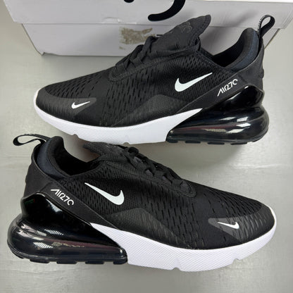 Nike Air Max 270 black trainers with white accents and logo detail.