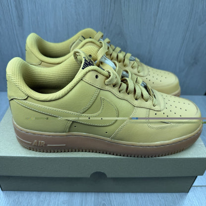 Nike Air Force 1 trainers brown suede upper with gum sole and logo detail.
