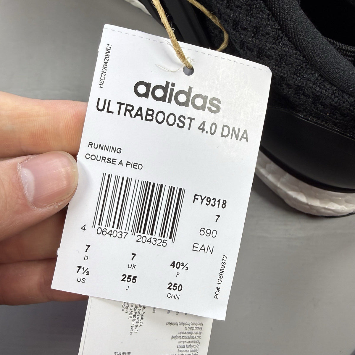 Adidas black Ultra Boost trainers with white accents and signature three-stripe logo.