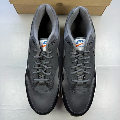 Nike black trainers with satin finish and pinwheel design details.