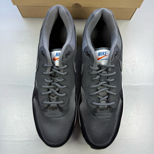 Nike black trainers with satin finish and pinwheel design details.