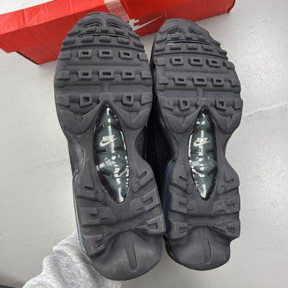 Nike Air Max 95 black trainers with grey accents and textured material.