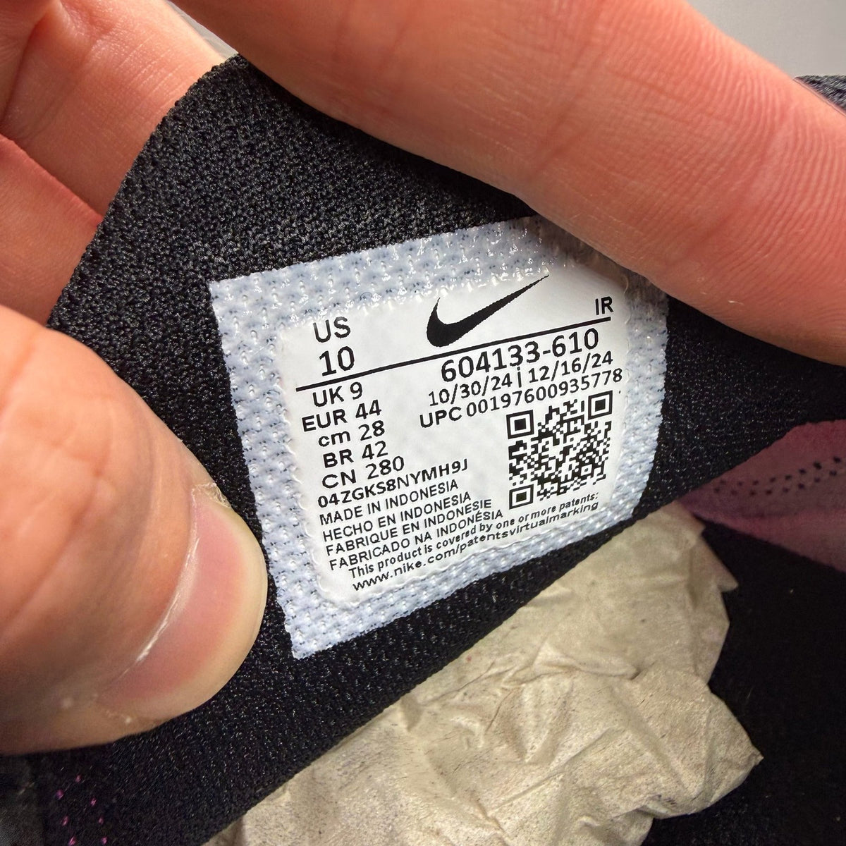 Nike Air Max Plus TN pink and purple trainers with distinctive wave pattern and logo.