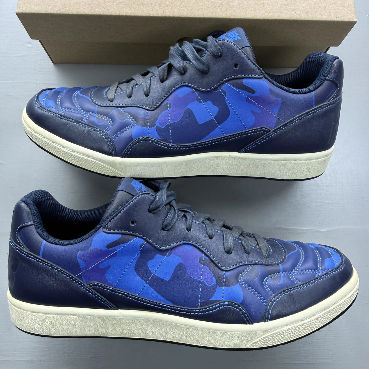 Nike blue trainers with obsidian camo pattern and logo detail.