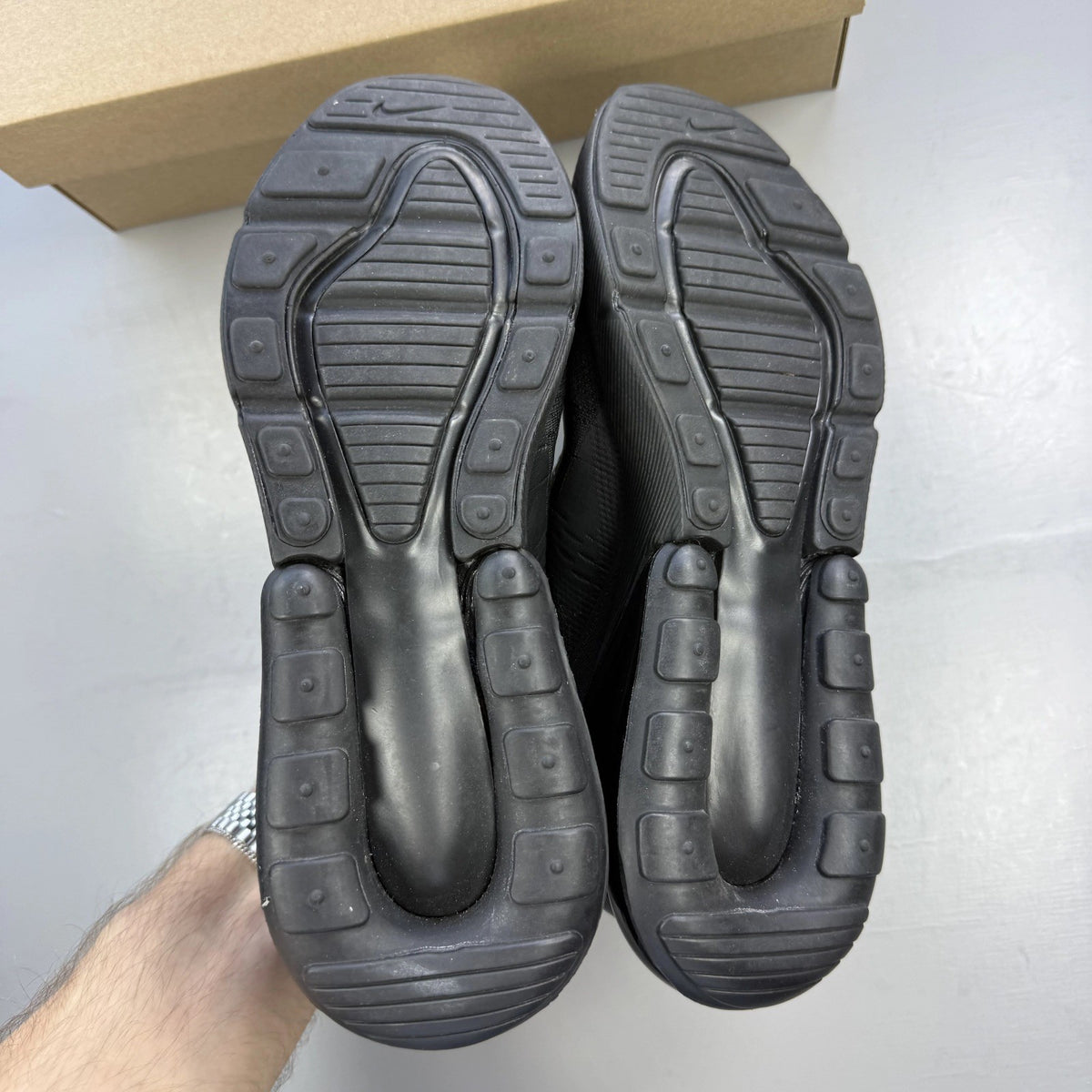 Nike Air Max 270 black trainers with logo detailing and breathable mesh upper.