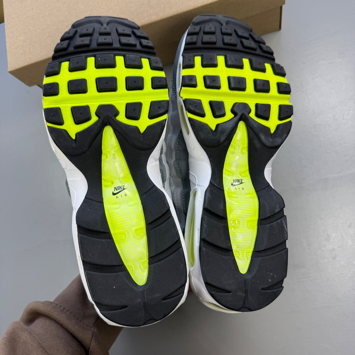 Nike trainers white with neon grey volt accents and retro logo details.