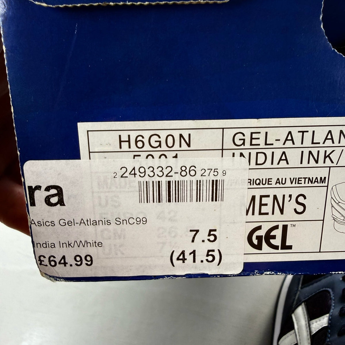 ASICS blue trainers with white accents and logo detail on the side.