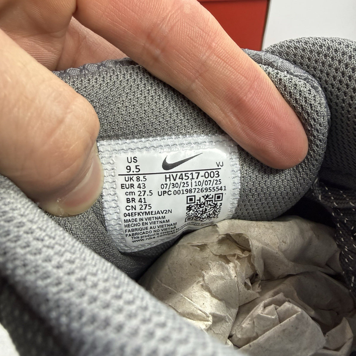 Nike Air Max 90 Premium grey trainers with black accents and signature swoosh logo.