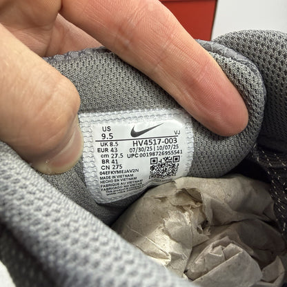 Nike Air Max 90 Premium grey trainers with black accents and signature swoosh logo.