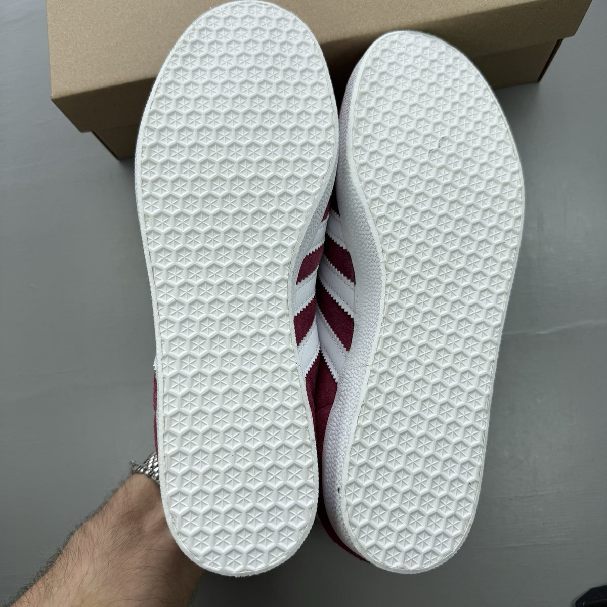 Adidas Gazelle trainers burgundy with white and gold accents, classic suede material.