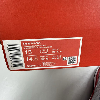 Nike P-6000 trainers in metallic silver with red and black accents, mesh upper.
