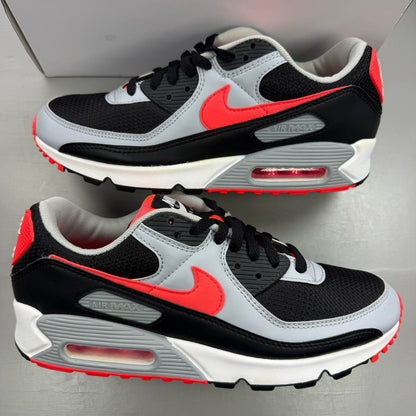 Nike Air Max 90 black trainers with radiant red and wolf grey accents, logo detail.