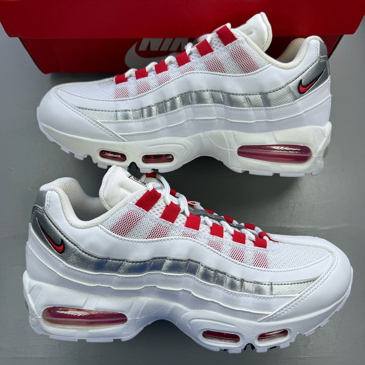Nike Air Max 95 white sneakers with signature big bubble sole and logo detail.