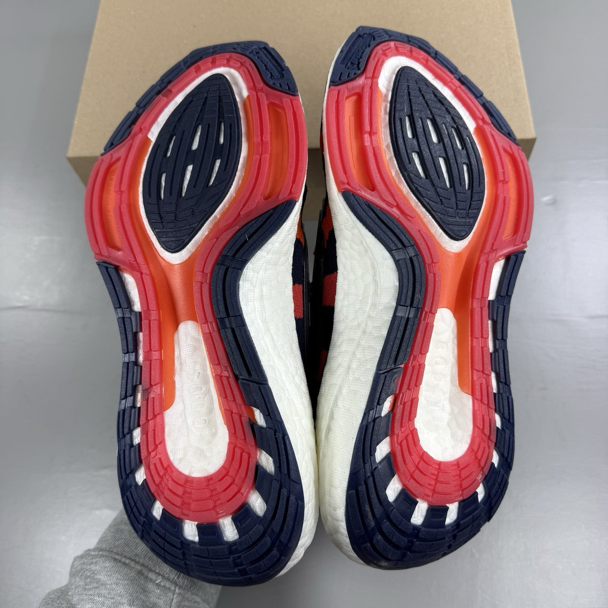 Adidas red Ultra Boost 22 trainers with Marimekko floral pattern and Parley branding.