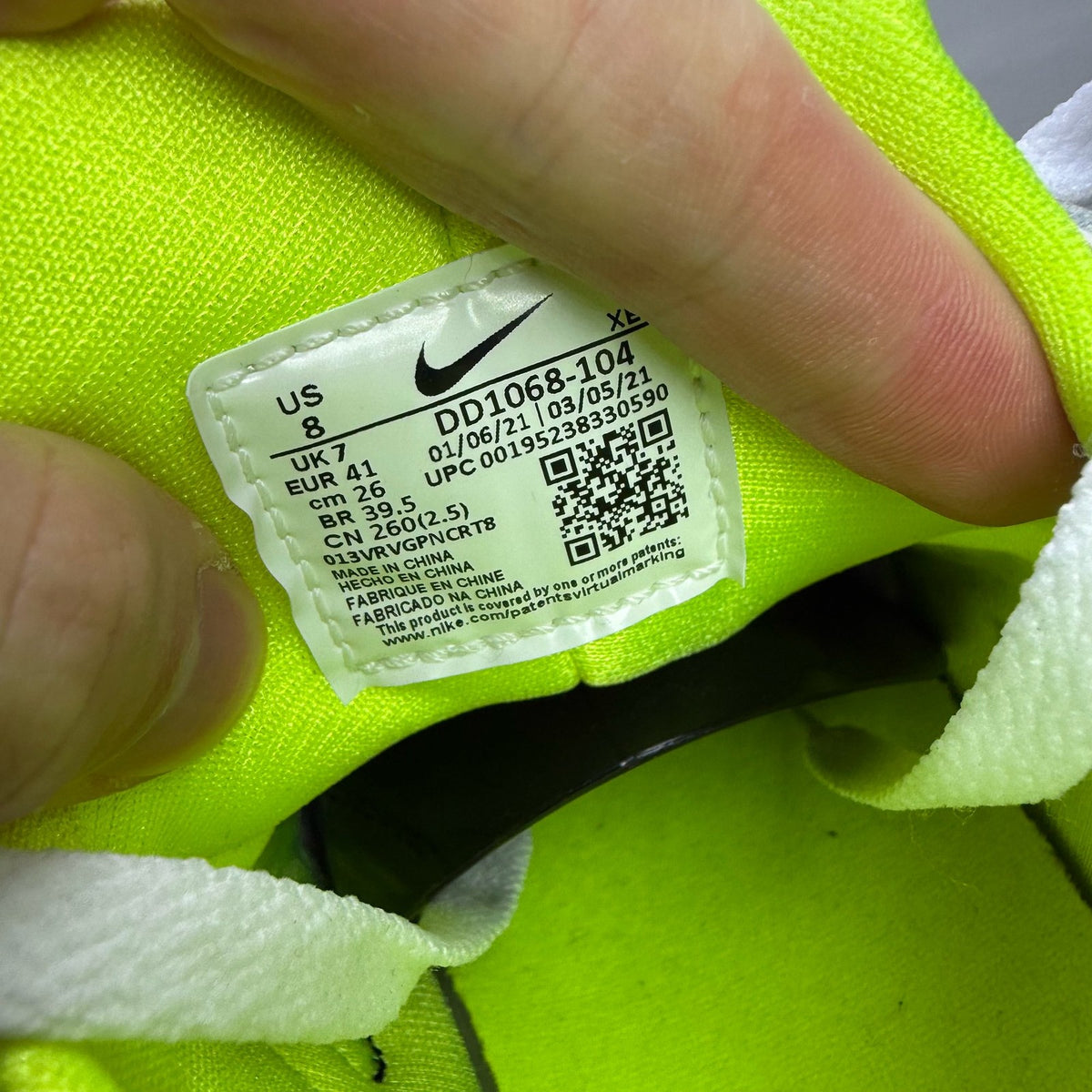 Nike white trainers with magenta and neon yellow accents, featuring classic Huarache design.