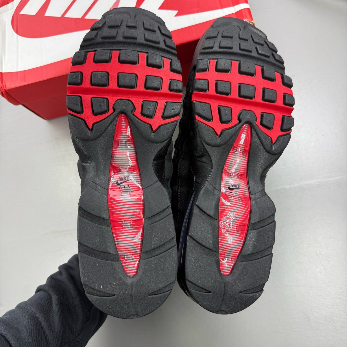 Nike Air Max 95 black sneaker with university red accents and big bubble sole design.