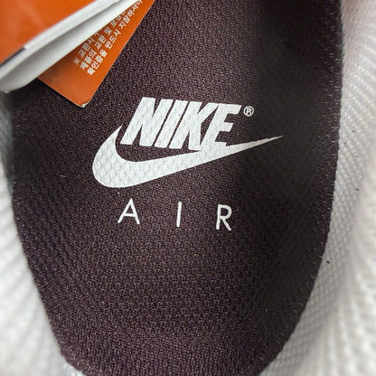 Nike Air Max 1 red trainers with white accents and signature swoosh logo.