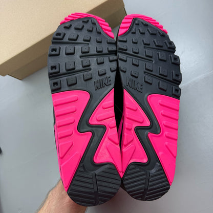 Nike Air Max 90 grey trainers with hyper pink accents and black detailing.