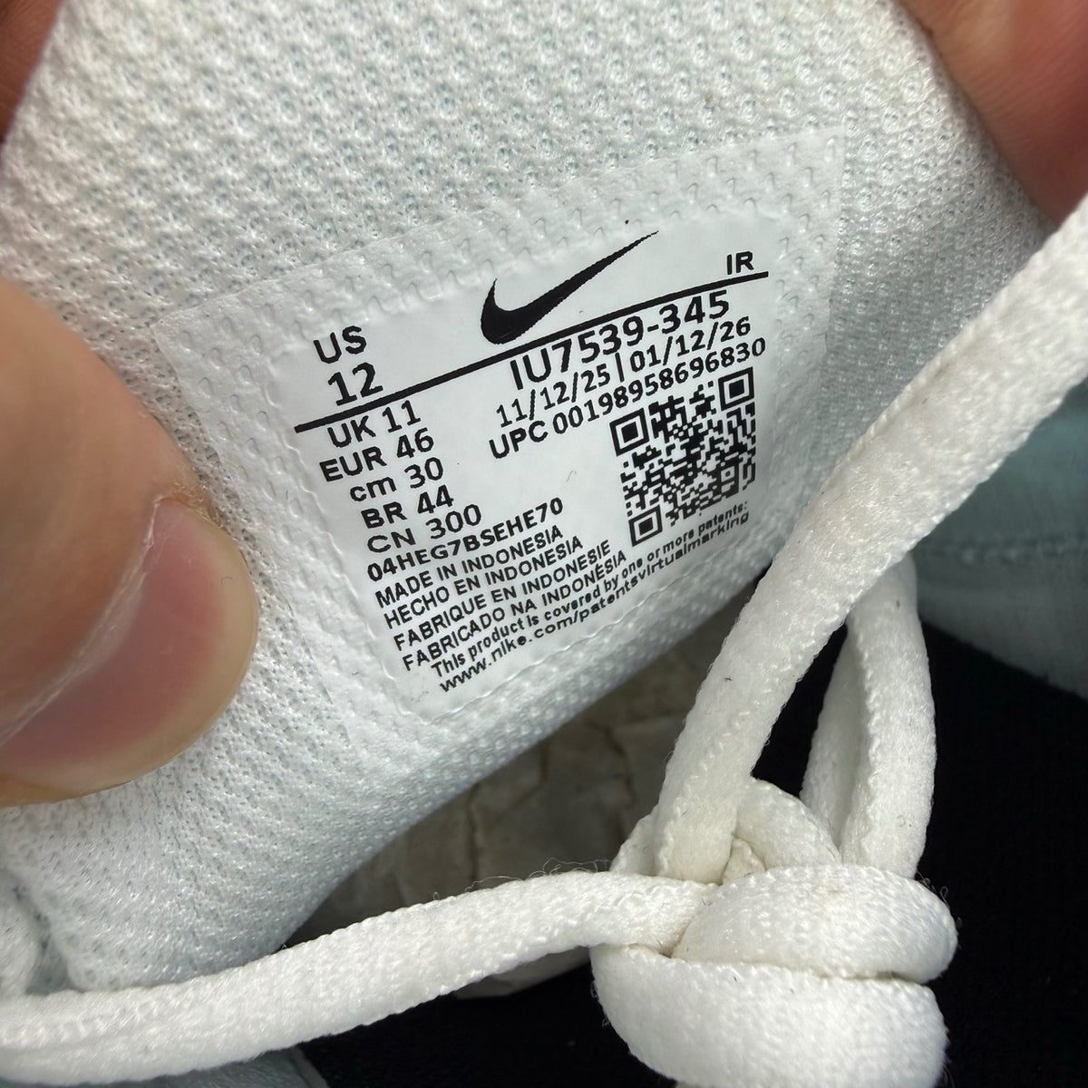 Nike deck shoes white with blue and black accents, featuring signature swoosh logo.
