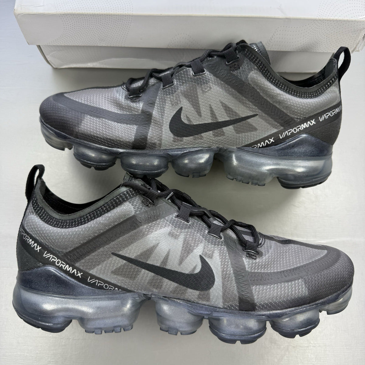 Nike Air VaporMax 2019 black trainers with grey accents and transparent sole design.