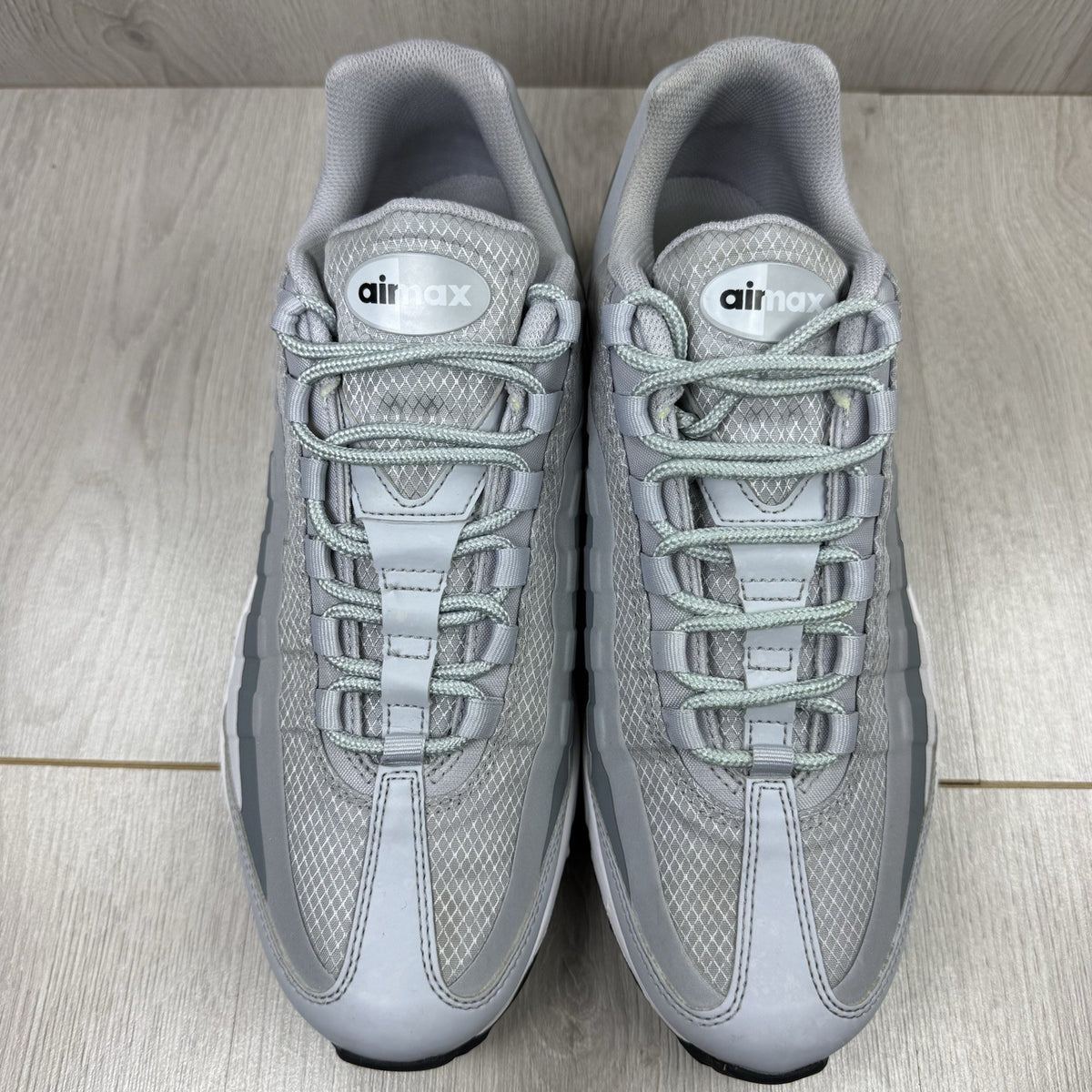 Nike Air Max 95 Ultra grey trainers with white accents and signature logo detailing.