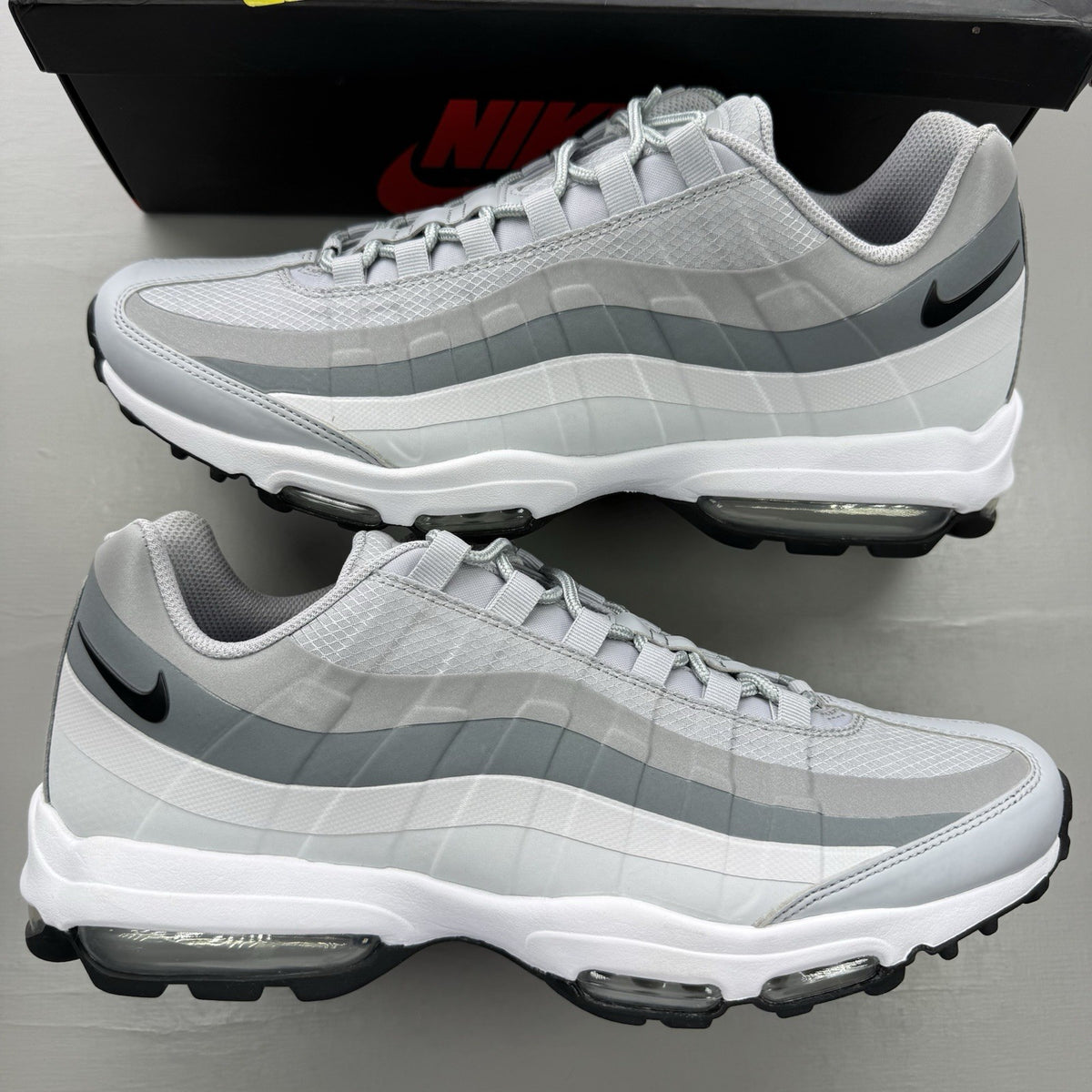Nike Air Max 95 Ultra grey trainers with black and white accents, mesh and leather material.