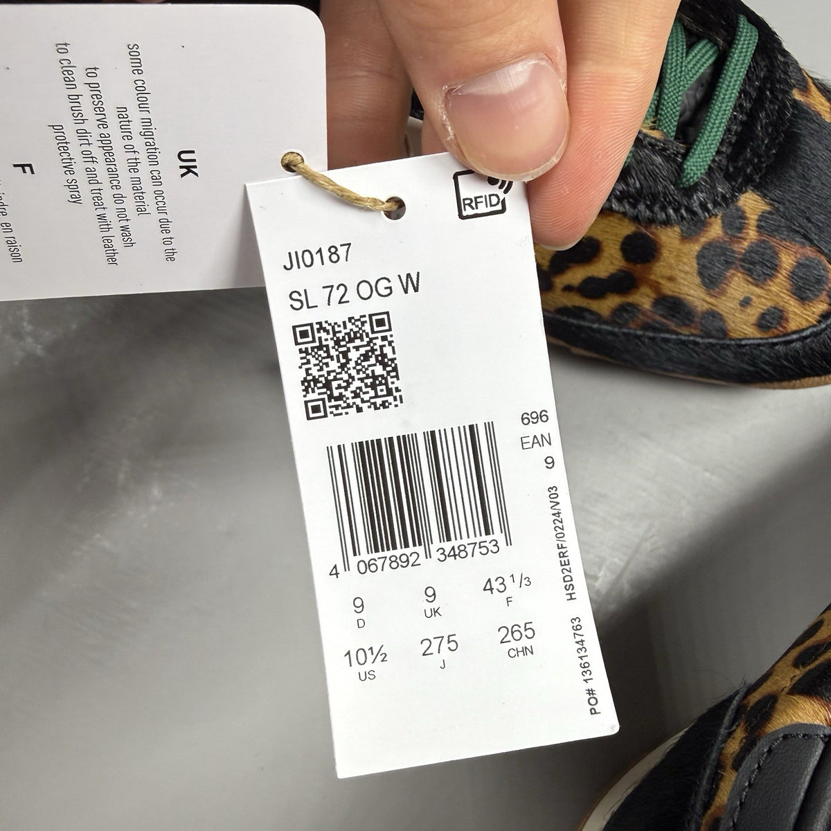 Adidas black trainers with leopard print accents and classic three-stripe logo.