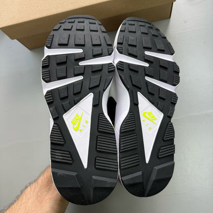 Nike white trainers with magenta and neon yellow accents, featuring classic Huarache design.