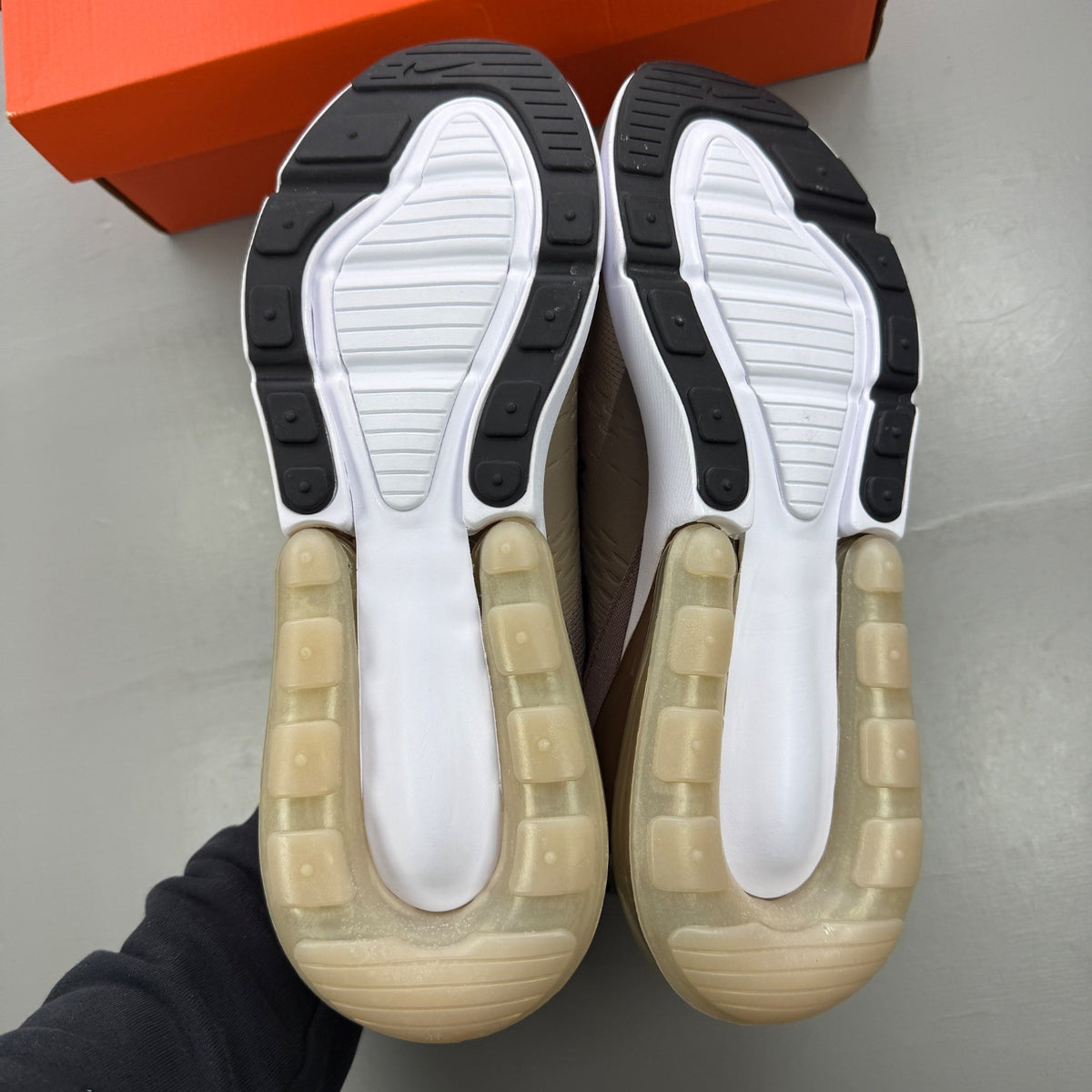 Nike brown trainers with Air Max cushioning and logo detail on the tongue.