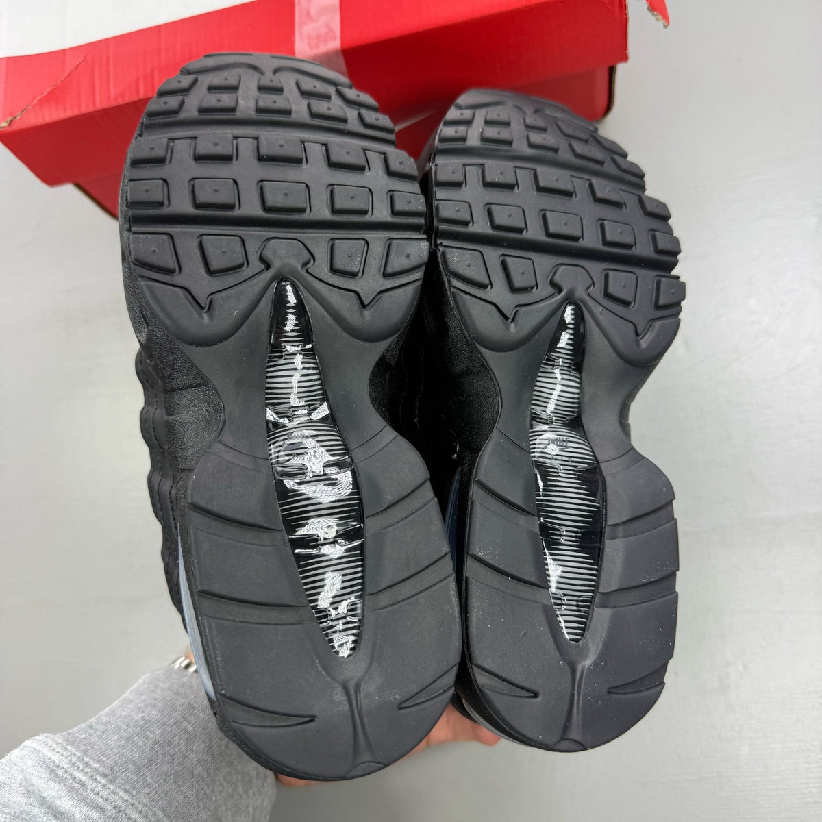 Nike Air Max 95 black trainers with big bubble sole and logo detail.