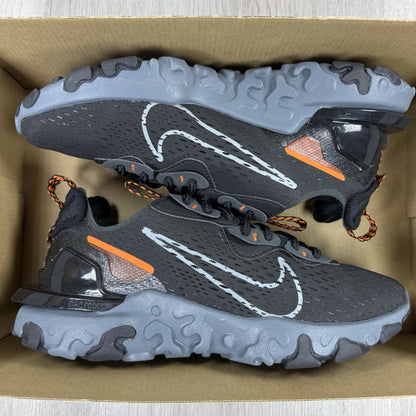 Nike React Vision black trainers with safety orange accents and unique design details.