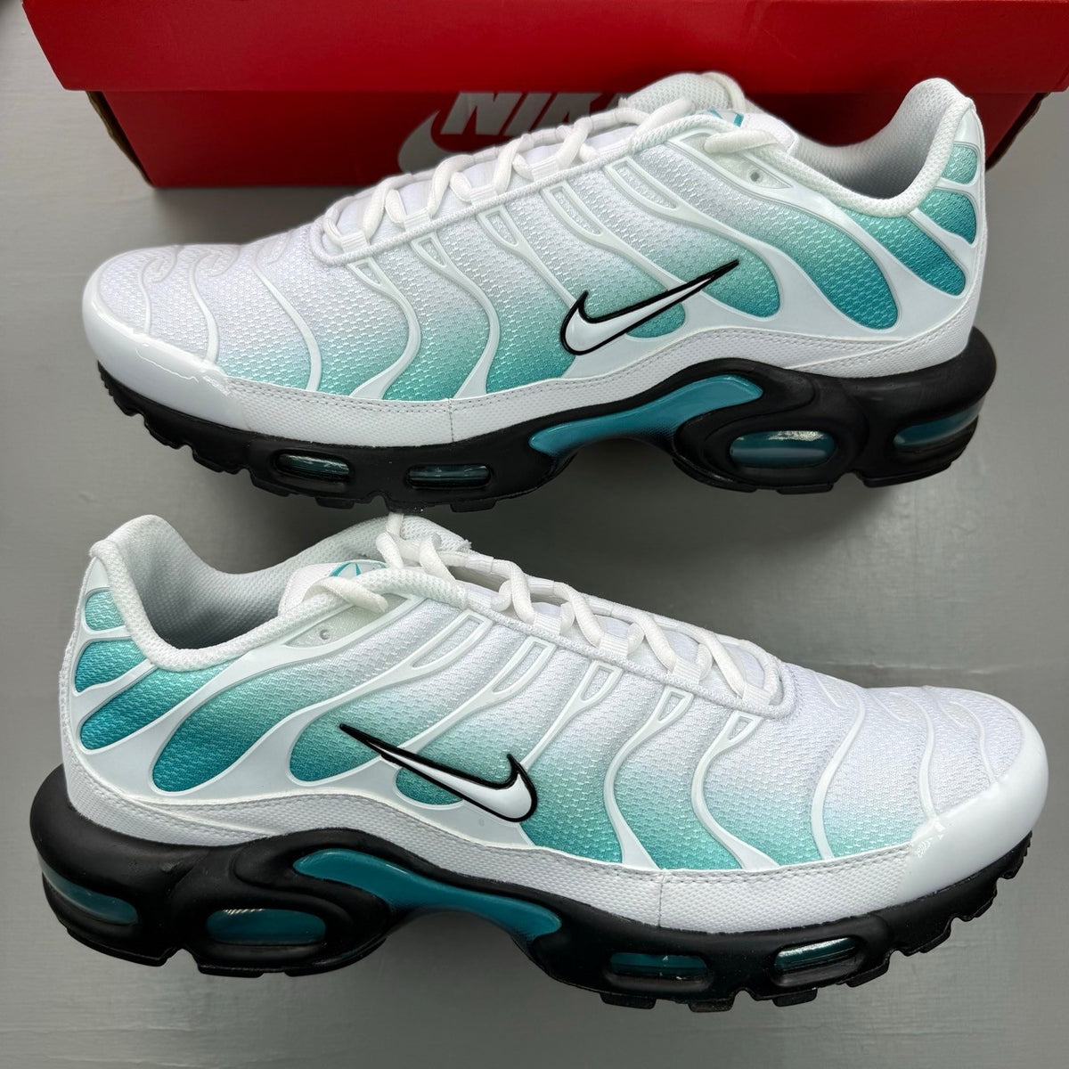 Nike deck shoes white with blue and black accents, featuring signature swoosh logo.