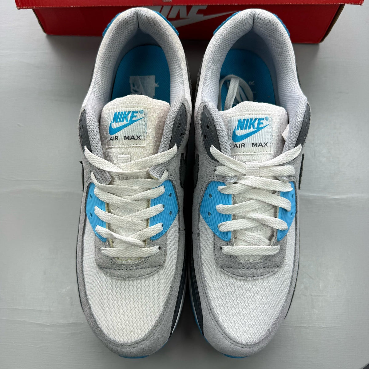Nike Air Max 90 grey trainers with blue accents and signature swoosh logo.