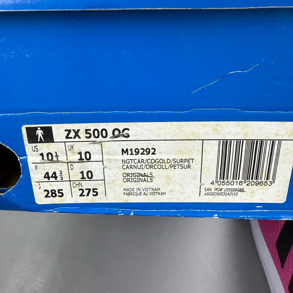 Adidas ZX Flux trainers in shock pink with black and blue accents, mesh upper.