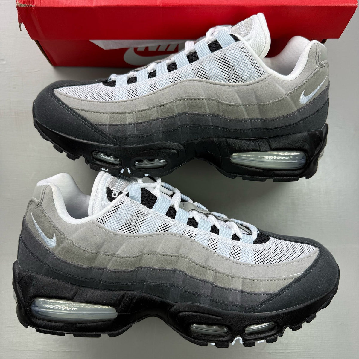 Nike Air Max 95 black trainers with big bubble design and reflective accents.