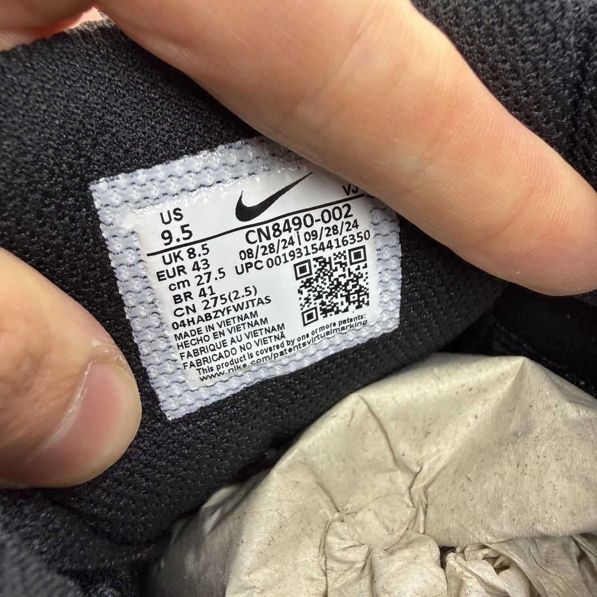 Nike Air Max 90 grey trainers with black and white accents, featuring logo details.