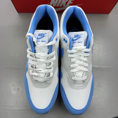 Nike Air Max 1 blue trainers with white accents and UNC logo detailing.