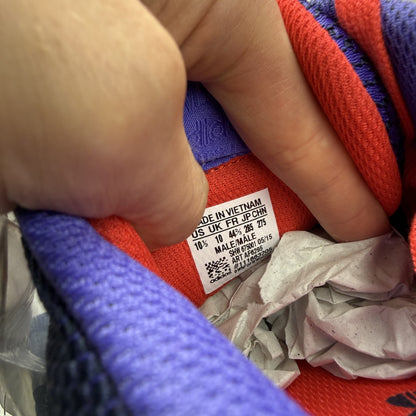 Adidas blue ZX Flux trainers with red and white woven pattern, logo on tongue.