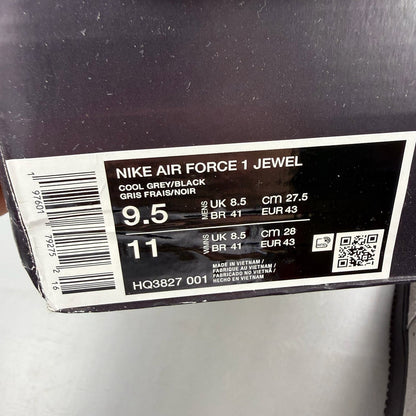 Nike Air Force 1 grey trainers with black accents and jewel logo detail.