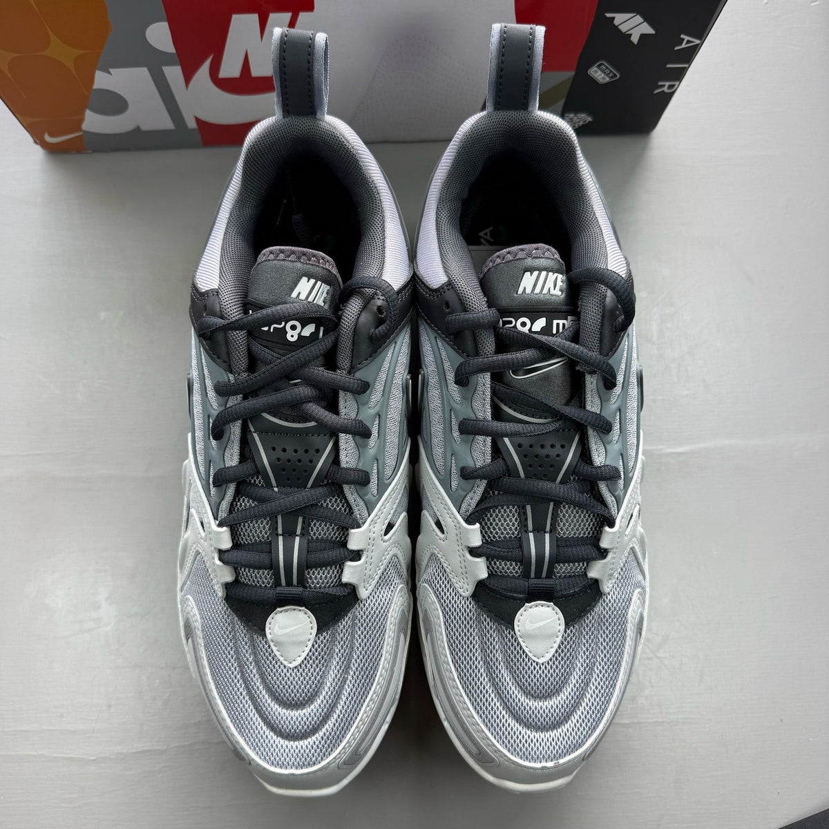 Nike grey trainers with Air cushioning, sleek design, and logo detail.