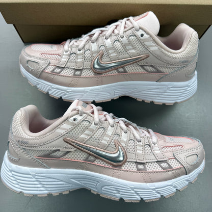 Nike P-6000 pink trainers with mesh upper and logo detailing.