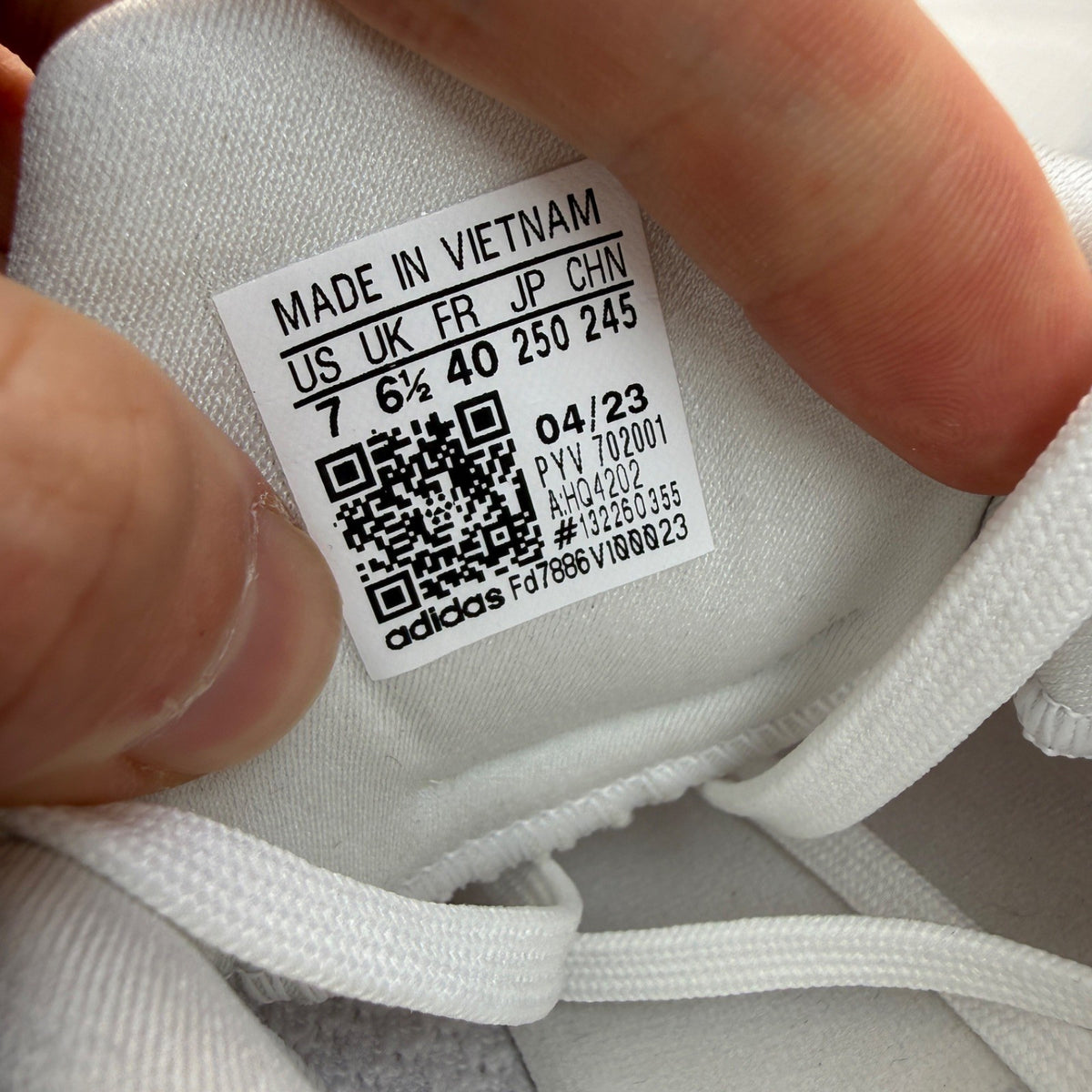 Adidas Ultra Boost 1.0 white running trainers with textured knit upper and signature three stripes.