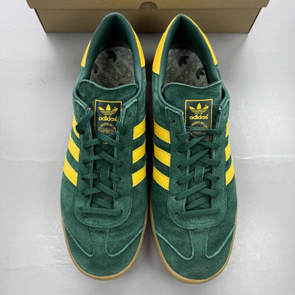 Adidas Hamburg green trainers with gold and yellow accents, featuring classic logo detail.