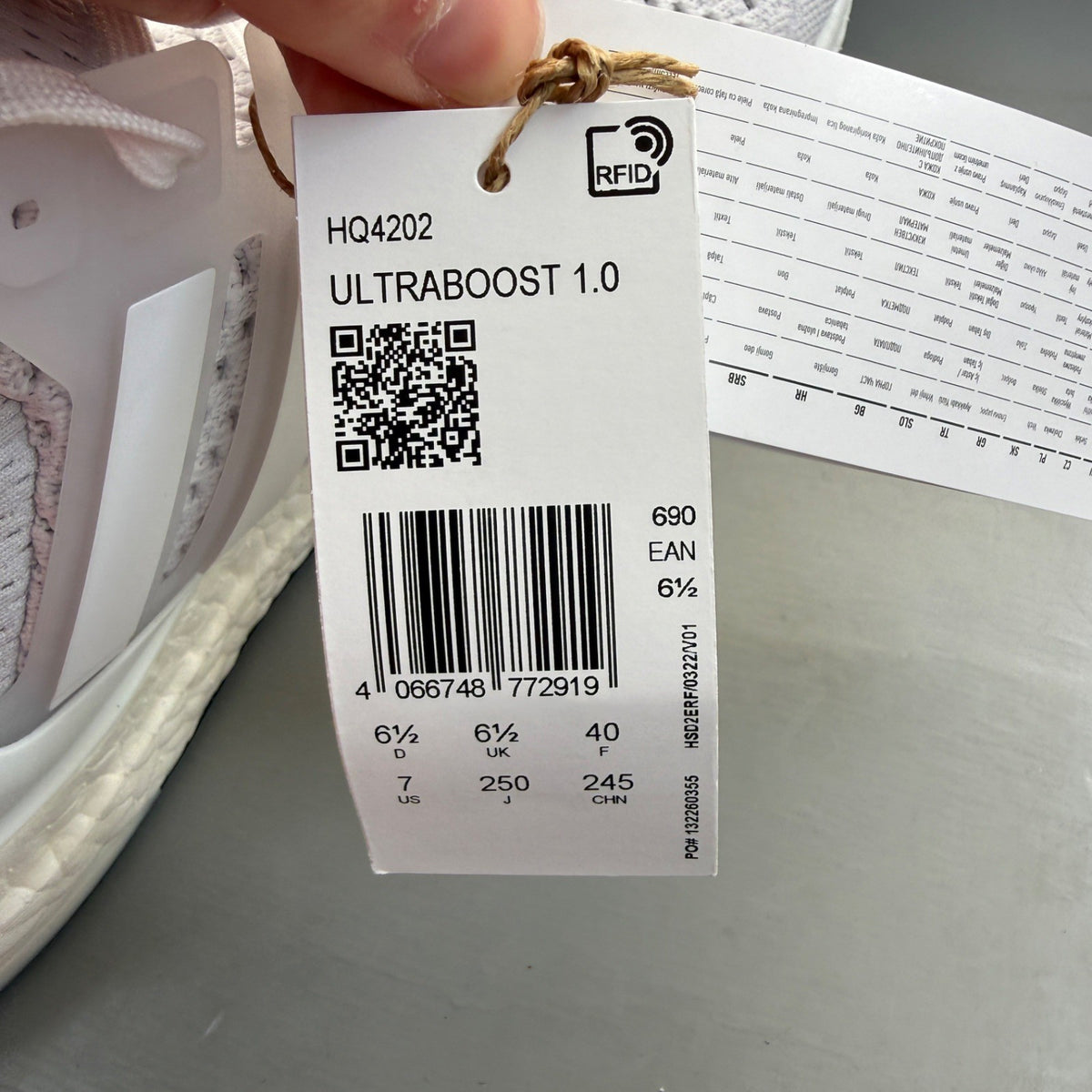 Adidas Ultra Boost 1.0 white running trainers with textured knit upper and signature three stripes.