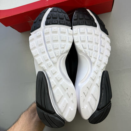 Nike black trainers with white accents and sleek design, featuring logo details.