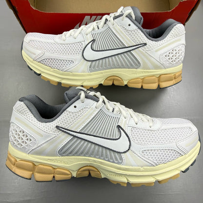 Nike Zoom Vomero 5 white trainers with grey accents and logo detailing.