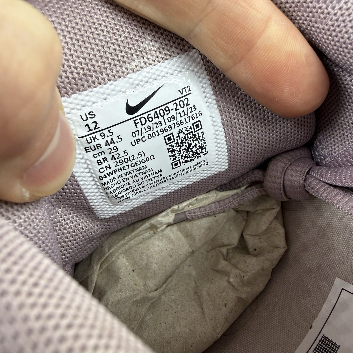 Nike Air Max Pulse purple trainers with unique design and textured material.