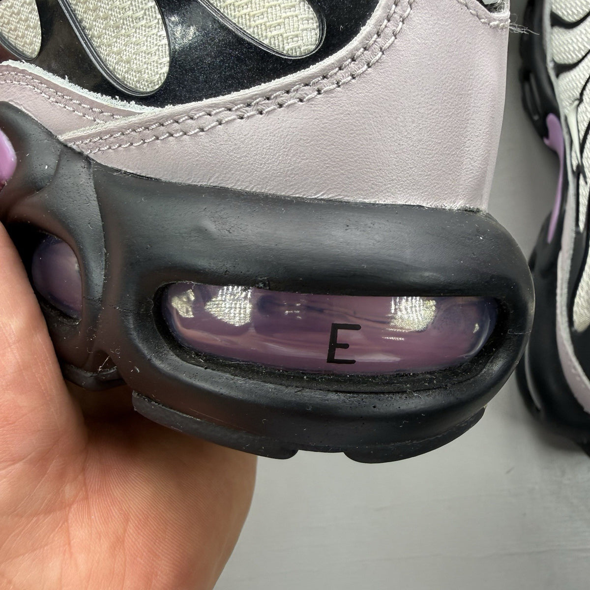 Nike Air Max Plus TN white trainers with black and purple accents, custom writing on bubbles.