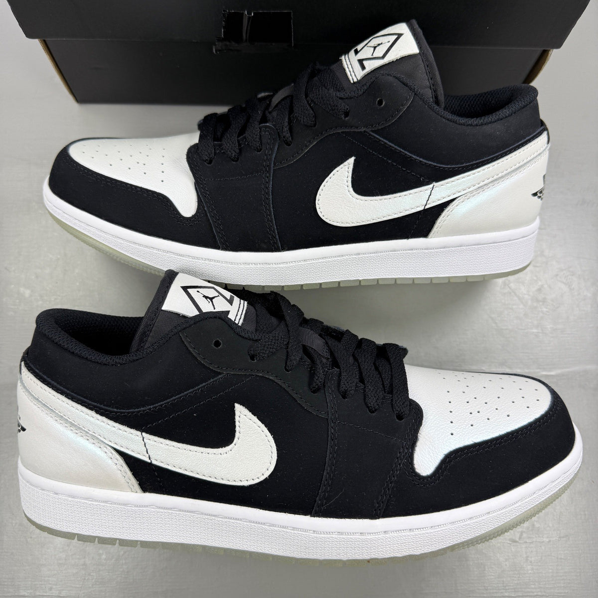 Jordan black athletic shoes with white accents and diamond pattern details.