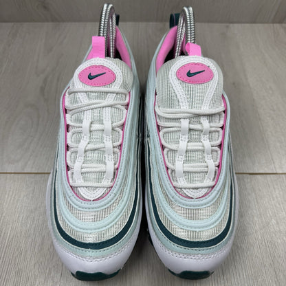 Nike Air Max 97 white trainers with teal accents and reflective detailing.